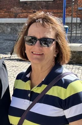 lady wearing sunglasses and striped polo shirt