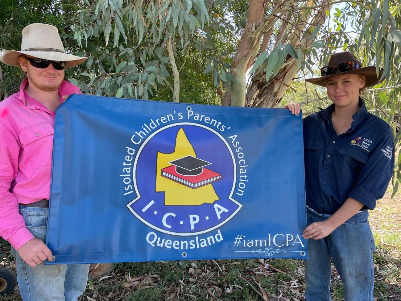 man and woman holding blue flag