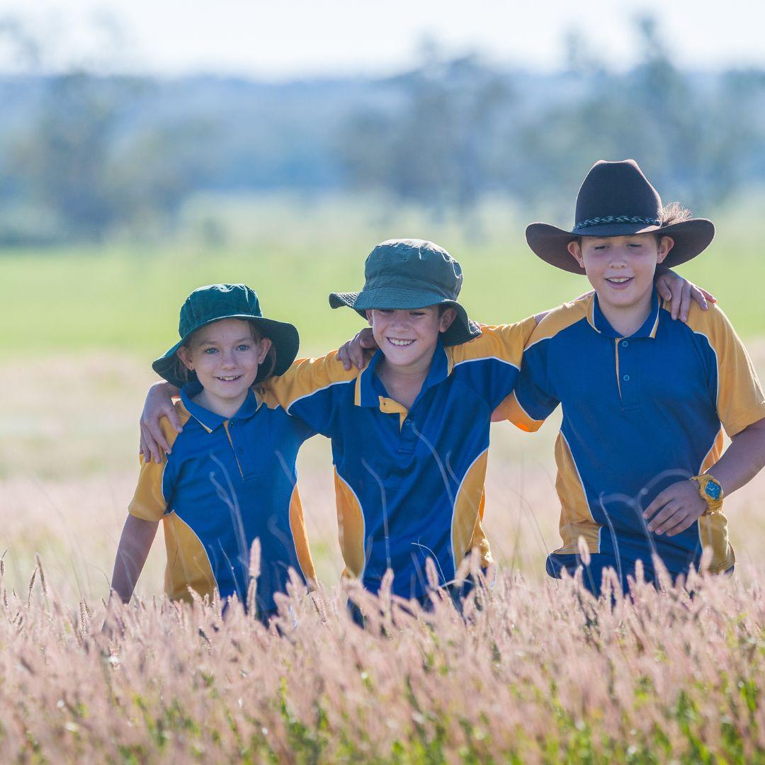 Children in uniforms in grass