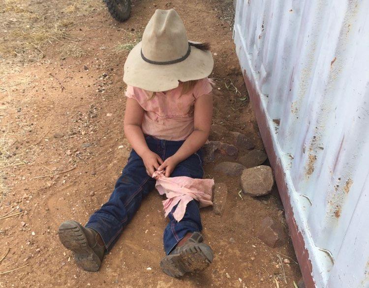 little girl sitting on ground