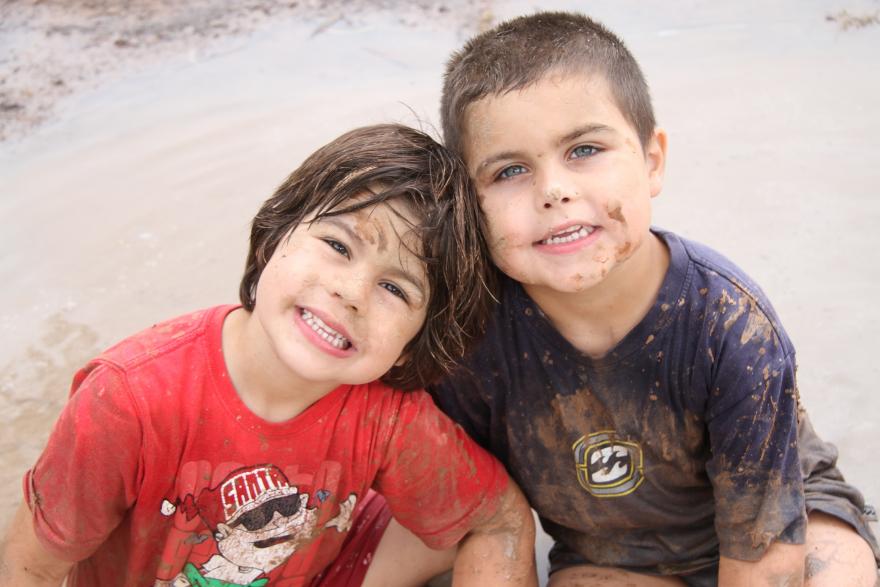 Young children in the mud