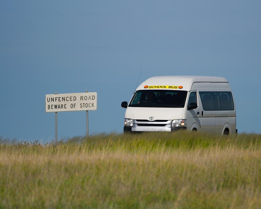 A picture of a school bus on a country road