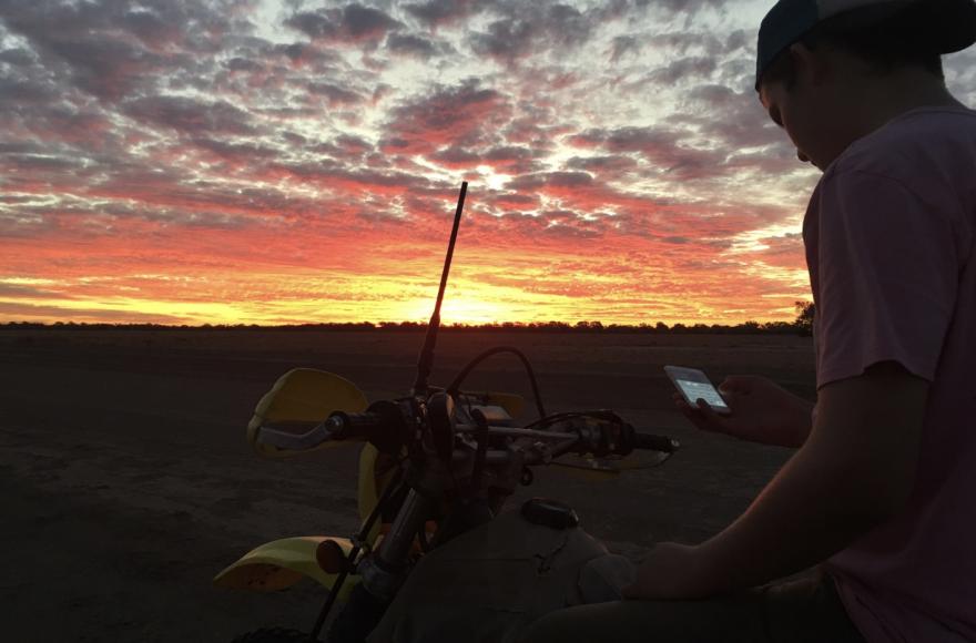 Child Using mobile phone in Outback