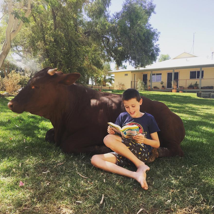 Jacob Keogh reading with his poddy