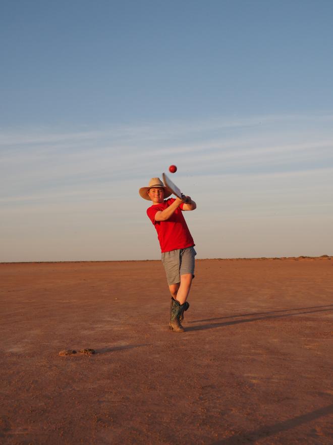 Boy playing cricket