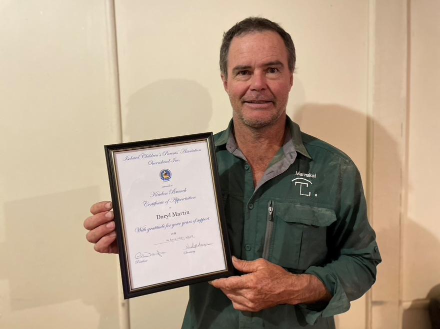 man holding award