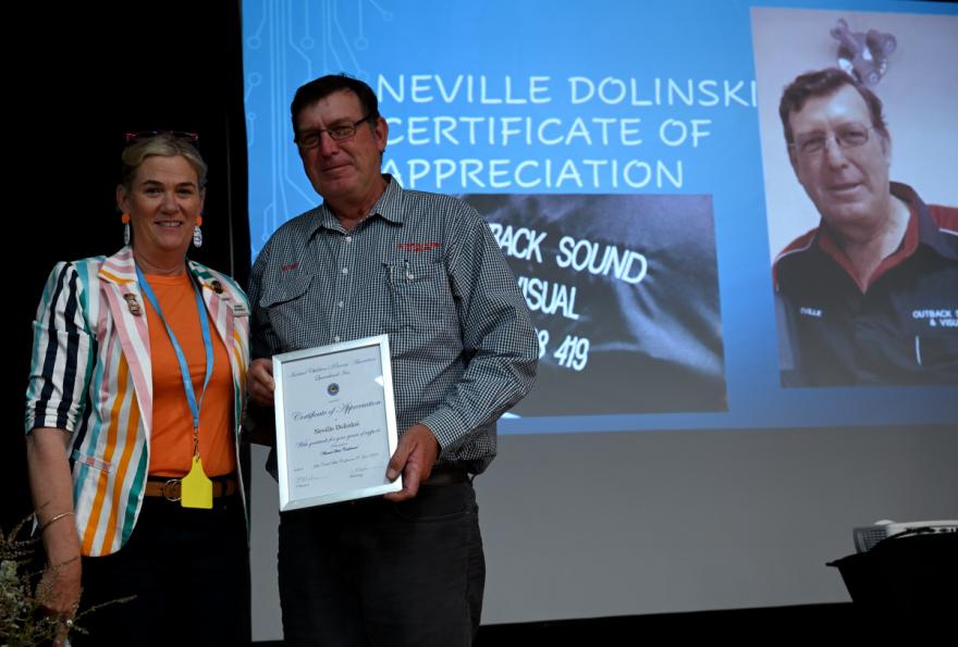 Son presenting Nev with certificate