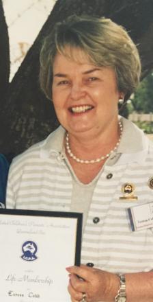 picture of Teresa wearing striped top holding membership certificate