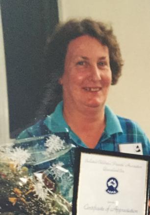 picture of Zilla carrying flowers and certificate