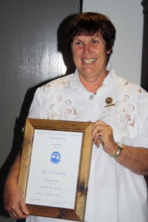 picture of Rose wearing a white top and holding certificate