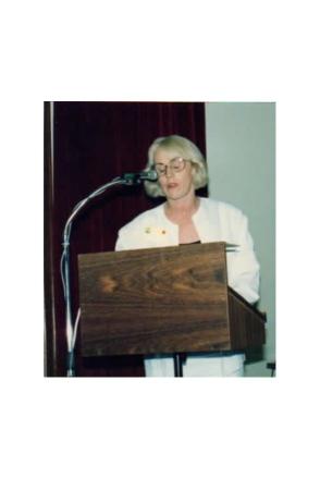 picture of Annette at lectern in white jacket