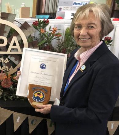 picture of Beryl wearing dark jacket with Certificate