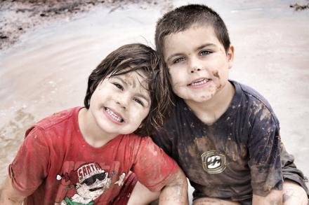 Two outback kids in mud