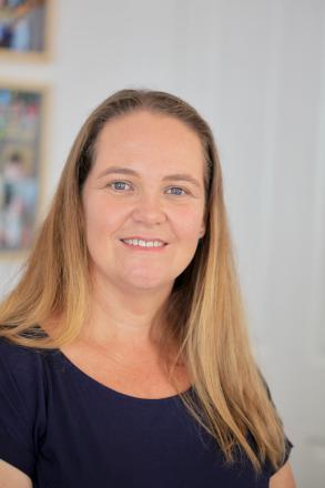 A picture of Tammie Irons close up wearing a navy top and long hair