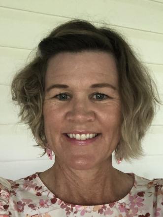 A picture of Kate Bradshaw close up with a pink flower shirt on