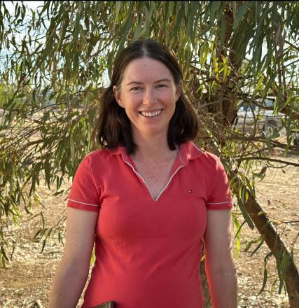 dark haired lady with red polo shirt