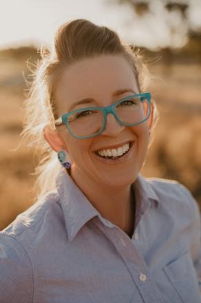 lady wearing blue rimmed glasses 