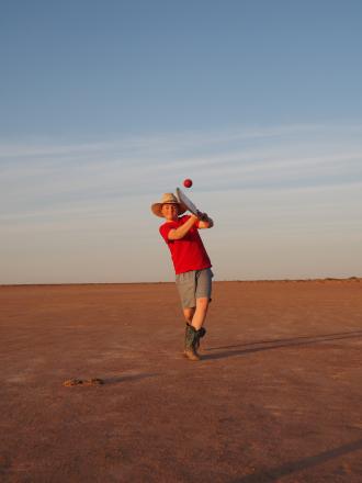 Boy playing cricket
