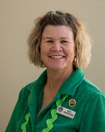 A picture of Kate Bradshaw in a green shirt wearing a badge