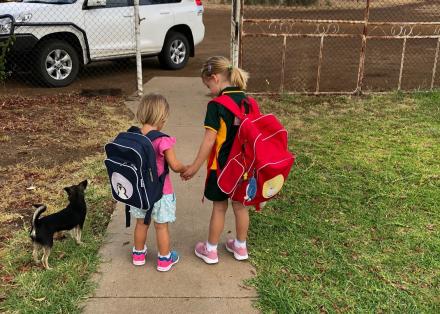 A picture of 2 children going to school