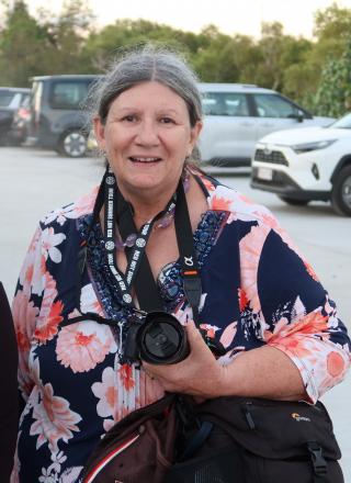 mary with navy and pink shirt and camera