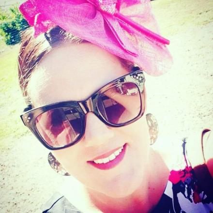 image of Rachel wearing glasses and a pink fascinator