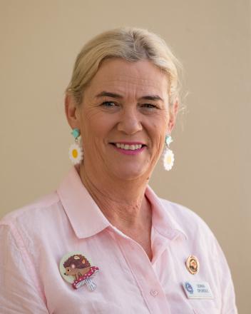 A picture of Sonia Spurdle in a pink shirt with a hedgehog brooch